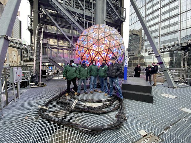 John Trowbridge at the far right with four other men, in front of the New Year's Eve ball